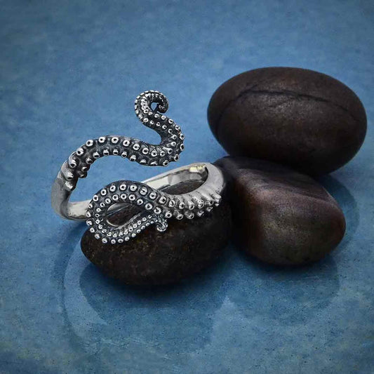 Close up of octopus tentacle 925 sterling silver adjustable ring for women. The octopus tentacles are oxidized with a darker finish and shiny silver suctions cup detail. 